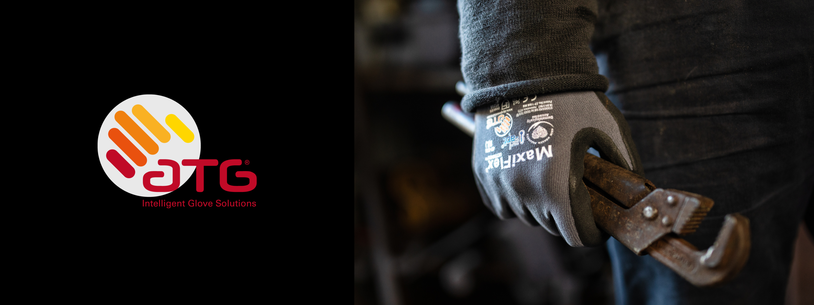 Close-up of a hand wearing an ATG work glove holding a rusty pipe wrench in a workshop setting. The ATG logo is visible in the image.